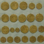 Rows of historic gold coins displayed for comparison