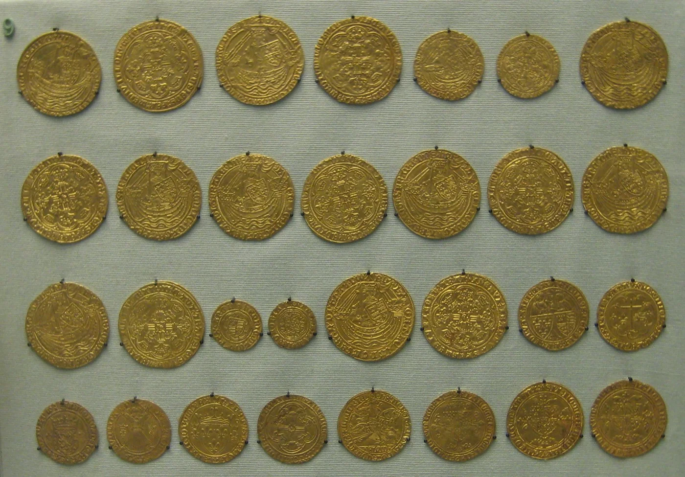 Rows of historic gold coins displayed for comparison